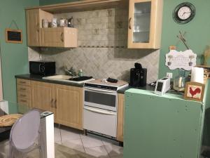 a kitchen with a stove and a refrigerator at la cave in Montoire-sur-le-Loir +17 photos