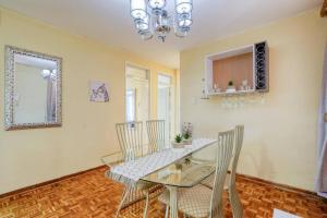 a dining room with a glass table and chairs at Lovely 2-bedroom apartment, with an amazing view in Durban