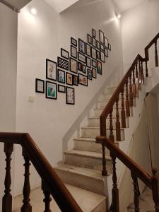 a staircase with pictures on the wall at Unpack Hostel in Puducherry