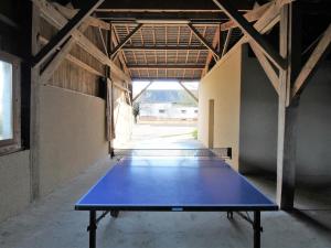 a ping pong table sitting inside of a building at Gîte Baugé en Anjou, 5 pièces, 9 personnes - FR-1-622-28 in Baugé-en-Anjou