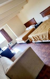 a room with three beds in a room at Metro Inn & Suites in Jacksonville