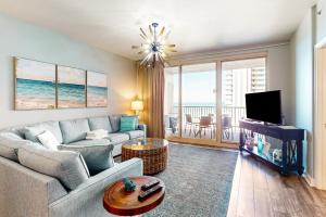 a living room with a couch and a tv at Shores of Panama III in Panama City Beach