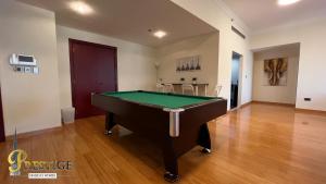 a living room with a pool table in it at Prestige in Dubai