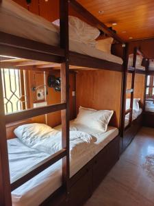 a room with three bunk beds in a house at Unpack Hostel in Puducherry