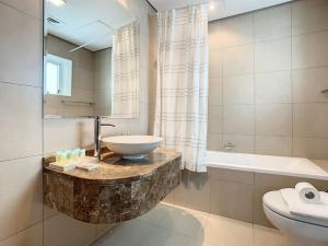 a bathroom with a sink and a bath tub at Key View - Hilliana Tower in Dubai