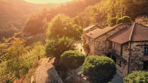 an aerial view of a stone house in a valley at Cascina Bertolotto Wine Resort in Spigno Monferrato