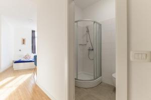 a bathroom with a shower and a toilet at Niva Rooms & Studio Apartment in Zagreb
