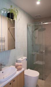 a bathroom with a shower and a toilet and a sink at Coastal Living in Comfort in Raglan