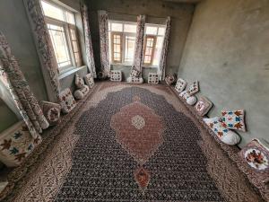 an aerial view of a room with a rug and windows at POP Home Sharik Homestay 