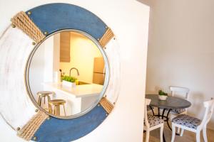 a large round mirror hanging on a wall in a dining room at Bay Views & Gaslamp/Little Italy/Convention 1BD in San Diego