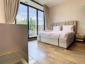 a bedroom with a large bed and a large window at Key View - Villa, Casa Flores in Dubai