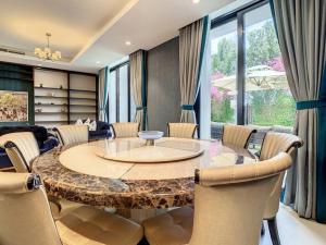 a dining room with a large table and chairs at Key View - Villa, Casa Flores in Dubai