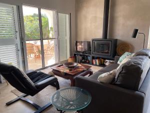 a living room with a couch and chairs and a tv at Chalet Las Brisas in Cullera +17 photos