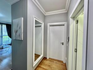 a hallway with a white door and a mirror at CasaAparta in Sofia