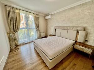 a bedroom with a bed and a large window at CasaAparta in Sofia
