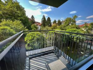 a balcony with a metal railing and trees at CasaAparta in Sofia