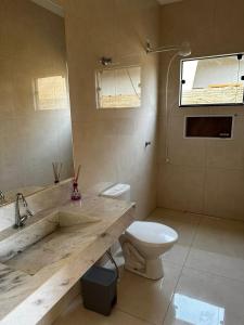a bathroom with a sink and a toilet in it at Casa Bela in Bonito