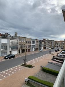 a view of a city street with buildings and cars at C-Blanche in Blankenberge