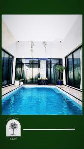 a large swimming pool in a building with windows at STAY Villa in Riyadh