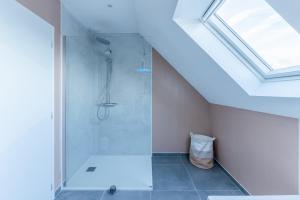 a bathroom with a shower in a attic at TY NEVEZ - Jolie maison neuve avec petite vue mer in Saint-Pabu +42 photos