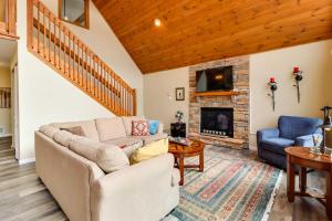 a living room with a couch and a fireplace at Lakefront Poconos Family Home with Pool Access in Pocono Lake