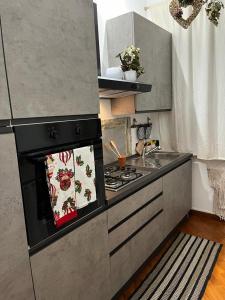 a kitchen with a stove top oven in a kitchen at La Ville in Torre del Greco