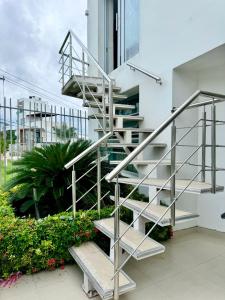 a metal spiral staircase next to a building at HELENE HOUSE in Sincelejo