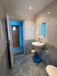 a bathroom with a sink and a toilet and a shower at Guest House Georgieva Ravda in Ravda