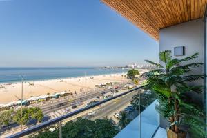 a view of the beach from the balcony of a building at Unhotel - Luxuoso Loft com Vista Mar na Praia de Copacabana in Rio de Janeiro