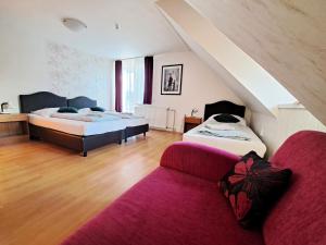 a living room with two beds and a couch at Alcorso Pension in Banská Bystrica