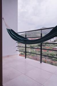 a hammock on a balcony with a view at Aires de Altura y Singani in Tarija