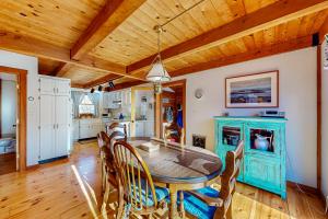 a kitchen and dining room with a table and chairs at Vineyard Vacation Cottage in Chilmark