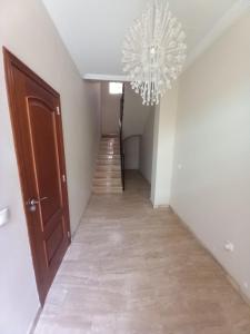 a hallway with a staircase with a chandelier at Apartamento Milán 