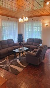 a living room with a couch and a coffee table at Greenview Homes in Eldoret