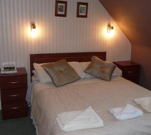 a hotel room with a bed and a lamp at St Annes Guest House in Oban