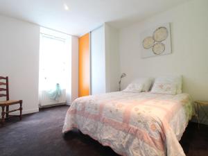 a white bedroom with a bed and a window at Gîte Chemillé-en-Anjou-Chemillé-Melay, 3 pièces, 4 personnes - FR-1-622-48 