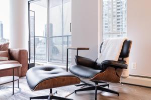 a chair in a room with a large window at Amazing Views ! Leather Furniture ! Cozy Condo! in Vancouver