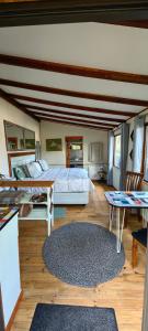 a large bedroom with two beds and a table at House of Art in Haenertsburg
