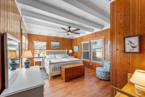 a bedroom with a bed and a ceiling fan at Bel Isle in Southern Shores