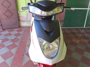 a motor scooter parked on a tile floor at Casa Vieja Guest House in Santa Ana