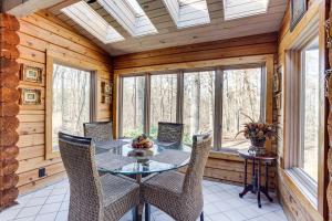 a dining room with a table and chairs in a cabin at Peaceful Lawrenceville Cabin with Hot Tub on 6 Acres in Lawrenceville