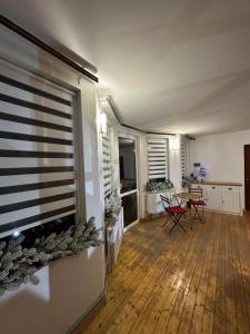 a living room with a large window and a table and chairs at HOTEL BOBROvski in Yasinya