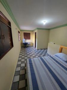 a bedroom with a bed and a table in a room at Duplex econômico vila ponta negra in Natal +1 photo