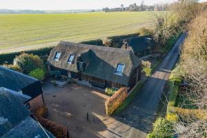 an aerial view of a house with a field at The Hayloft in Canterbury