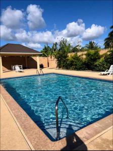 a large swimming pool with blue water at palmview estate townhouse in Mammee Bay