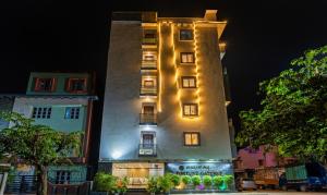 a tall building with lights on it at night at Treebo Fortune Gateway in Bangalore