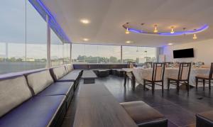 a dining room with tables and chairs and a tv at Treebo Sai Fortune Gateway in Bengaluru +20 photos