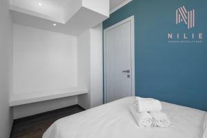 a bedroom with a bed with towels on it at V1 Penthouse, Nilie Hospitality MGMT in Thessaloniki