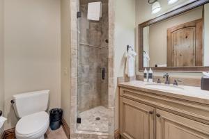a bathroom with a shower with a toilet and a sink at Vintage on the Strand by All Seasons Resort Lodging in Park City