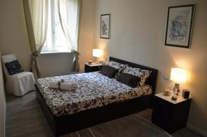 a bedroom with a bed with two tables and two lamps at Heart of Parma in Parma